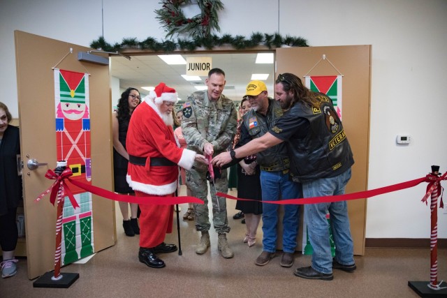 Brig. Gen. Thomas Feltey, III Armored Corps deputy commanding general of maneuver, cuts the ribbon with Santa and representatives of the American Legion Riders Nov. 16 at Santa&#39;s Workshop at The Great Place. (U.S. Army photo by Blair Dupre,...