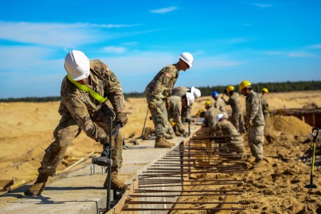 Soldiers from 902 Engineer Construction Company, 15th Engineer Battalion, 18th Military Police Brigade, tear down the framework after pouring concrete at the Pre-Engineered Building construction site in support of Operation Resolute Castle at Presidential Range, Poland, Sept. 21, 2023. Resolute Castle 23 is a multi-national exercise that increases partner capacity and strengthens capabilities across NATO through real world engineer related training, which enhances NATO&#39;s ability to project combat power throughout Europe.