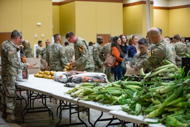Soldiers load fresh produce into bags to be given away during the Chaplain Turkey Giveaway Nov. 15 at the Main Post Chapel. (U.S. Army photo by Blair Dupre, Fort Cavazos Public Affairs)