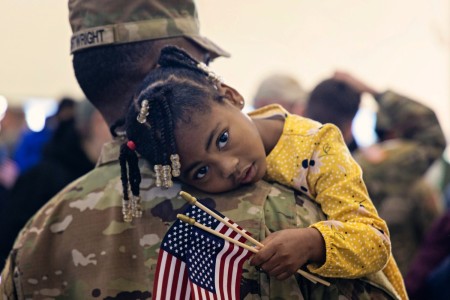 A young girl hugs a Soldier during a deployment ceremony for more than 150 Delaware Army National Guardsmen in New Castle, Delaware, Jan. 13, 2023. The citizen Soldiers are scheduled to deploy to southwest Asia for one year in support of U.S. Central Command.