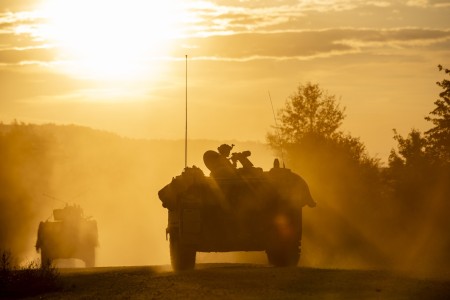 A convoy of U.S. Army Soldiers and vehicles from 1st Battalion of the 4th Infantry Regiment, playing the role of opposition forces, rolls through a training village with various armored vehicles during Saber Junction 23 at the Joint Multinational Readiness Center near Hohenfels, Germany, Sept. 13, 2023. U.S. and multinational soldiers play the role of enemy forces during the exercise to provide integrated, total force training for combat readiness. Saber Junction 23 is an annual U.S. Army exercise with NATO allies and partners including 4,000 participants from 16 different countries training together from Aug. 28 to Sept. 23, 2023. The primary training audience for the exercise is the 2nd Cavalry Regiment, a U.S. Army Stryker Brigade Combat Team based in Germany. While U.S.-led, this exercise will develop and enhance NATO allies and partners’ interoperability and readiness. 
