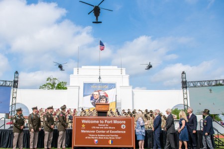 Fort Moore leaders, along with members of the Moore family (at right), unveil an official Fort Moore sign during a redesignation ceremony May 11 held at the post’s historic Doughboy Stadium.