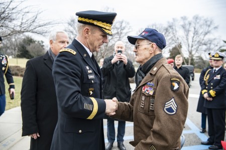 Chief of Staff of the Army Gen. James McConville (left) speaks with Darrell Bush (right), 98, a former U.S. Army Staff Sergeant and a WWII veteran of the Battle of the Bulge, at Arlington National Cemetery, Arlington, Virginia, Jan. 25, 2023. Bush was at ANC to view a wreath-laying ceremony at the Battle of the Bulge monument, commemorating the ending of the Battle of the Bulge on this date in 1945.