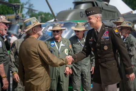 Chief of the National Guard Bureau U.S. Army Gen. Daniel R. Hokanson, right, greets members of the North Carolina Vietnam Helicopter Pilots Association during the Vietnam Veterans “Welcome Home” Celebration at the west end of JFK Hockey Fields on the National Mall in Washington, D.C., May 11, 2023.