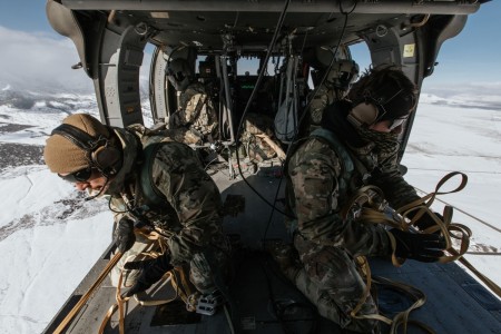 U.S. Army Jumpmaster-qualified Paratroopers assigned to the 19th Special Forces Group (Airborne), pull in the static lines in a UH-60 Black Hawk Helicopter after a successful exit of 6 paratroopers on January 21, 2023, near Camp Williams, Utah.