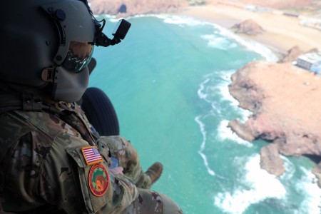 U.S. Army Sgt. Andrew Wilwol, a flight paramedic with the 1-111th Aviation Regiment, 78th Aviation Troop Command, Georgia Army National Guard, watches the Moroccan coast pass along below him while enroute to Inezgane Airfield in Agadir, Morocco, June 11, 2023, during Exercise African Lion 2023. Eighteen nations and approximately 8,000 personnel will participate in AL23, U.S. Africa Command&#39;s largest annual combined, joint exercise that will take place in Ghana, Morocco, Senegal, and Tunisia from May 13-June 18, 2023.