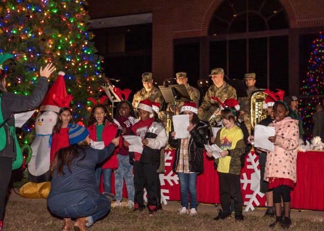 Children from Fort Leonard Wood’s School Age Center sing holiday songs in front of 399th Army Band Soldiers during the 2022 tree-lighting ceremony. This year’s event is set to begin at 5:30 p.m. Monday on the Maneuver Support Center of...