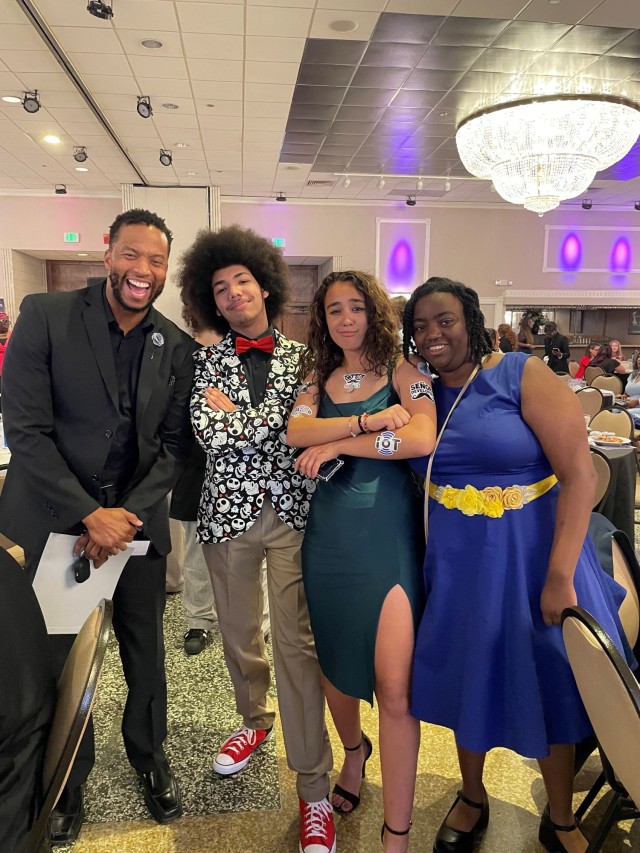 Rick Burton, a patent security specialist for U.S. Army Combat Capabilities Development Command, or DEVCOM, far left, poses for a photo with Pathways in Technology, or P-Tech, students June 7, 2023, at the Richlin Catering & Event Center in...