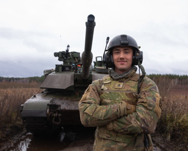 U.S. Army Staff Sgt. Jaden Brown, a tank commander with Alpha “Ares” Company, 3rd Battalion, 67th Armored Regiment, 2nd Armored Brigade Combat Team, 3rd Infantry Division, stands in front of his tank during the Strong Griffin exercise at Pabrade Training Area, Lithuania, Nov. 16, 2023. Strong Griffin 2023 saw Task Force Marne Soldiers serve as an opposing fighting force for the Griffin Brigade of the Lithuanian Armed Forces, which provided an opportunity to share Allied tactics and strategies. The 3rd Infantry Division’s mission in Europe is to engage in multinational training and exercises across the continent, working alongside NATO allies and regional security partners to provide combat-credible forces to V Corps, America’s forward deployed corps in Europe. (U.S. Army photo by Sgt. Cesar Salazar Jr.)