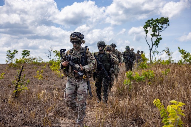 U.S. Army Soldiers assigned to 1st Battalion, 26th Infantry Regiment, 2nd Brigade Combat Team, 101st Airborne Division (Air Assault) and Brazilian Army soldiers assigned to 52nd Battalion, 23rd Infantry Brigade conduct movement after arriving at the landing zone in an air assault operation in Amapá, Brazil, during Exercise Southern Vanguard 24, Nov. 8, 2023. Southern Vanguard, an annual bilateral exercise which rotates between partner nations in the U.S. Southern Command area of responsibility, is designed to enhance partner interoperability between the U.S. and partner nation forces. (U.S. Army photo by Spc. Joshua Taeckens)