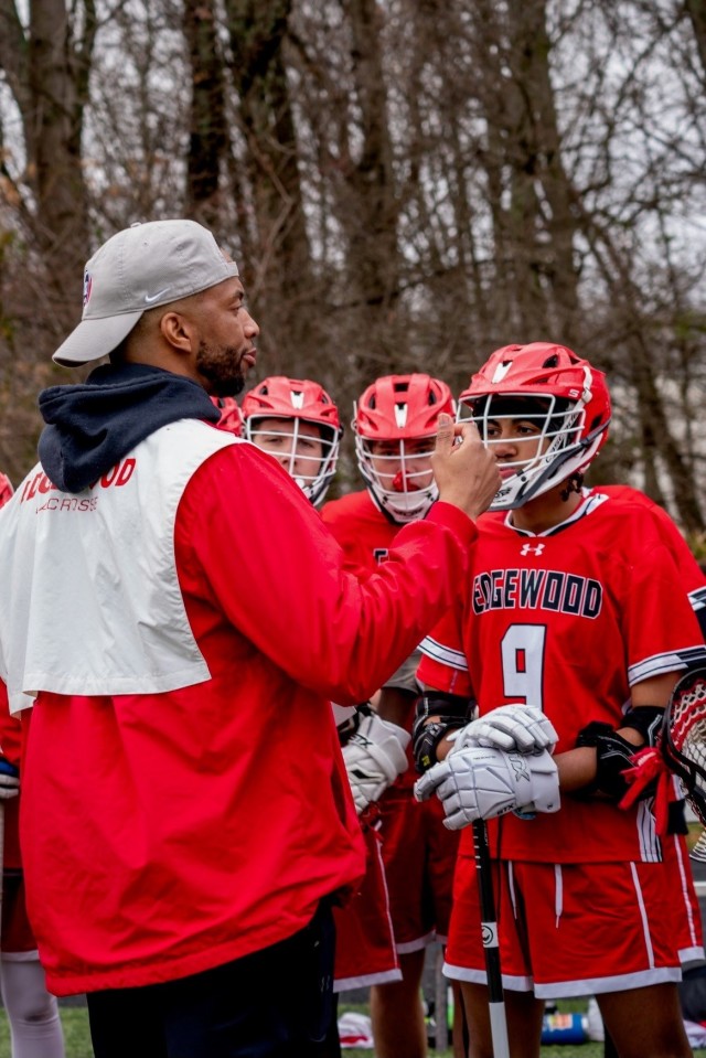 Rick Burton, a patent security specialist for U.S. Army Combat Capabilities Development Command, or DEVCOM, discusses game strategies with the Edgewood High School lacrosse team March 24, 2023. Burton serves as the team’s coach.