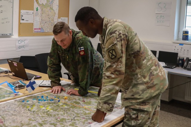 A U.S. Soldier from the 10th Mountain Division and a Soldier from the Finnish Army look over a map from a simulated brigade command post during Combined Resolve 24-01 at the Joint Multinational Readiness Center near Hohenfels, Germany, Oct. 29, 2023.The Finnish Army, working with their U.S. counterparts, replicated a brigade virtually during the exercise.

Combined Resolve 24-01 is a reoccurring U.S. Army Europe and Africa Training Exercise, designed to prepare U.S brigade combat teams, NATO allies and partners in support of NATO deterrence initiatives. Approximately 4,000 Soldiers from 14 nations participated in this event. (U.S. Army photo by Sgt. Rebecca Call)