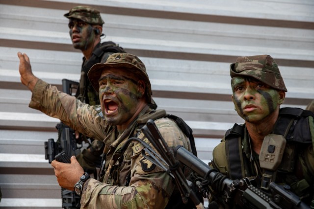 U.S. Army Sgt. 1st Class Andrew Tuitama, an infantryman assigned to Charlie Company, 1st Battalion, 26th Infantry Regiment, 101st Airborne Division (Air Assault), shouts commands above the noise of a simulated firefight during Exercise Southern Vanguard 24 in Oiapoque, Brazil, on Nov. 12, 2023. Southern Vanguard is an annual exercise at the operational and tactical levels to increase interoperability between U.S and Western Hemisphere forces, in this instance, Brazil. (U.S. Army National Guard photo by Spc. Joseph Liggio)