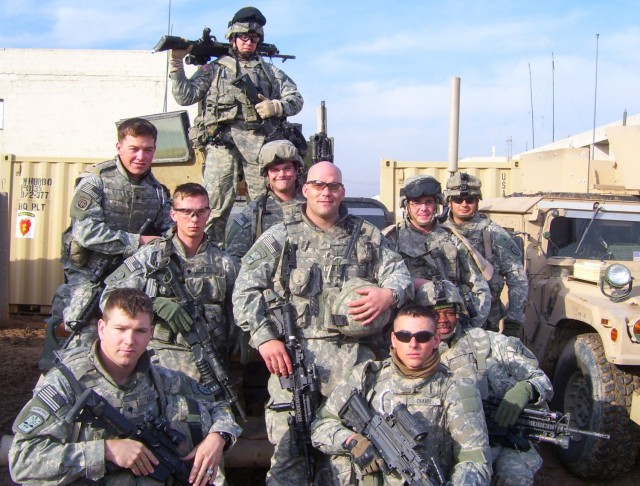 Then-Staff Sgt. Rick Dean, center, poses for a photo with his squad members during their deployment to Iraq in 2006. Following his tour, Dean, now a chief warrant officer 4, switched careers to become a UH-60 Black Hawk helicopter pilot and will soon retire after 26 years of service.