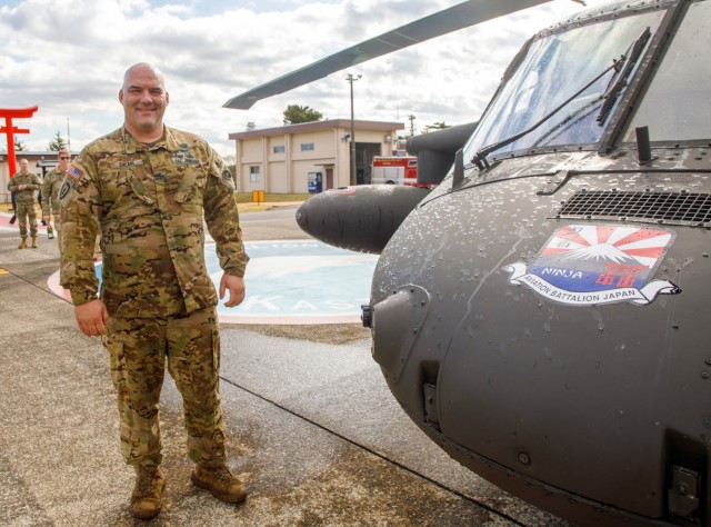 Chief Warrant Officer 4 Rick Dean, assigned to U.S. Army Aviation Battalion–Japan, poses for a photo next to his UH-60 Black Hawk helicopter after completing his final flight at Camp Zama&#39;s Kastner Airfield in Japan, Dec. 1, 2023. Dean served 26 years in the Army, much of them as a helicopter pilot.