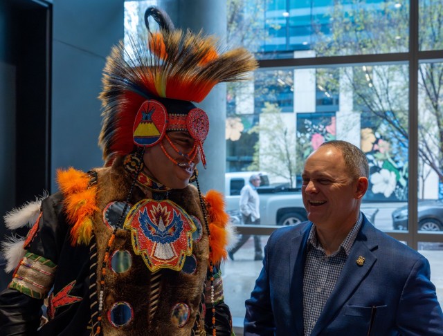 A Native American dancer with the Austin-based nonprofit Great Promise for American Indians speaks with Army Futures Command Chief of Staff Maj. Gen. Edmond “Miles” Brown.