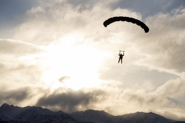 A U.S. Army paratrooper from the 4th Quartermaster Company, 725th Brigade Support Battalion (Airborne), 2nd Infantry Brigade Combat Team (Airborne), 11th Airborne Division, descends over Malemute Drop Zone during military freefall training at Joint Base Elmendorf-Richardson, Alaska, Nov. 30, 2023. Air Force special warfare Airmen, Alaska Air National Guard aviators, and Army paratroopers conducted the joint airborne sustainment training to ensure mission readiness in an arctic environment.