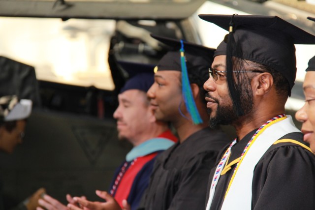 Sergeant First Class Jon Morris listens intently during his ACES graduation ceremony from Southern New Hampshire University at Fort Novosel on December 6, 2023.