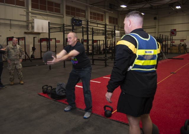 Chaplain (Capt.) David Sisco, with 3rd Battalion, 10th Infantry Regiment, learns how to perform the Army Combat Fitness Test standing power throw event more efficiently from Master Sgt. Colin Kerr, with the Maneuver Support Center of Excellence...