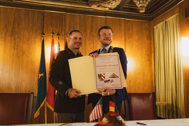 Brig. Gen. Steven P. Carpenter, Commanding General of 7th Army Training Command (7ATC), went to the Nürnberg Town Hall to sign a partnership agreement with Marcus König, Lord Mayor of Nürnberg, in Nürnberg, Germany, Dec. 1, 2023. The partnership agreement is a formal declaration of the unity and commitment to teamwork shared by members of the U.S. Army stationed in Bavaria and the people and leadership of the city of Nürnberg. (U.S. Army photo by Sgt. Christian Carrillo)