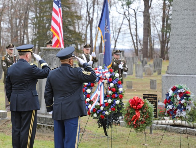 New York Army National Guard Maj. Gen. Michel Natali and Command Sgt. Maj. Edwin Garris salute after placing a wreath from the White House marking the birthday of former President Martin Van Buren in Kinderhook, New York, Dec. 5, 2023. Natali...