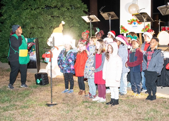 Children from Fort Leonard Wood’s Child and Youth Services program sing holiday songs prior to the tree lighting Monday on the Maneuver Support Center of Excellence Plaza.
