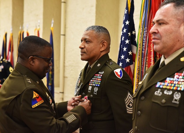 Maj. Gen. David Wilson presents Sgt. Maj. Felix Lassus with the Legion of Merit