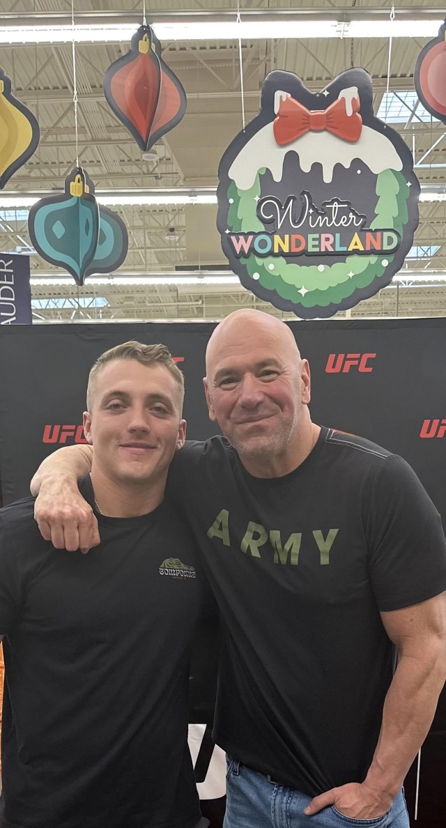 Spc. Trey Thacker, 3rd Battalion, 8th Cavalry Regiment, poses with Dana White during a meet and greet Nov. 30 at the Fort Cavazos Main Exchange. (Courtesy photo)