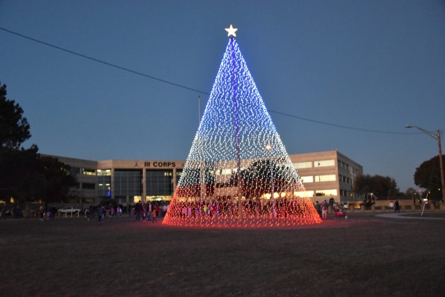 The 50-foot-tall tree is made up of 9,000 lightbulbs and stands in front of III Armored Corps Headquarters. (U.S. Army photo by Monty Campbell, Fort Cavazos Public Affairs)