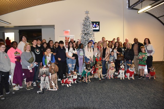 Thirty-seven Gold Star families headed to Walt Disney World in Orlando, Florida, pose for a photo with Fort Cavazos leadership, volunteers and supporters Dec. 2 at Killeen-Fort Hood Regional Airport. (U.S. Army photo by Janecze Wright, Fort Cavazos Public Affairs)