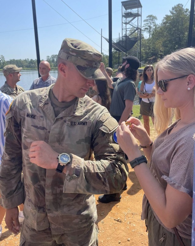 Kentucky Army National Guard 2nd Lt. Dustin McKie-Miller's girlfriend, Army Capt. Carly Schroeder, puts the Ranger Tab patch on his arm after his graduation from Ranger School at Fort Moore, Georgia, Aug. 18, 2023. McKie-Miller aced every...