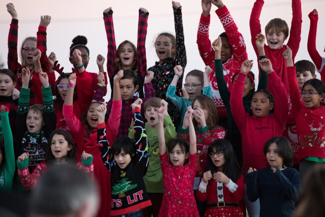 Children in the Meadows Elementary School Choir sing a song to entertain the crowd at the Holiday Tree Lighting Ceremony Dec. 1. (U.S. Army photo by Blair Dupre, Fort Cavazos Public Affairs)