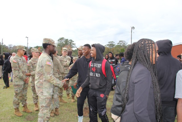 Pvt. Dusenge Jean-Chrisostome is congratulated by students from Hillcrest High School in Conecuh County, Alabama at the Hometown Heroes Army Recruiting event on Dec. 8, 2023 after his promotion.