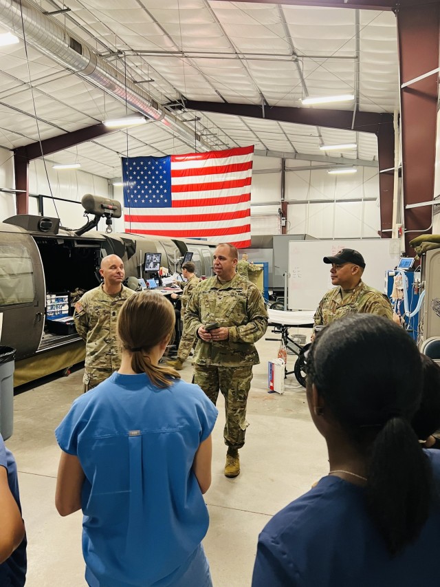 The Garrison Commander Col. John P. Miller, and Garrison Command Sgt. Maj. Christopher T. Doss speak with the students touring the Dustoff Training Complex on how the healthcare field in the military impacts not just the military community and its...