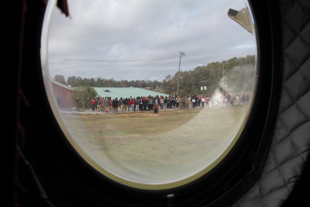 The view from inside the CH-47 Chinook helicopter as it lifts off from Hillcrest High School football field after the Hometown Heroes recruiting event in Conecuh County, Alabama on December 8, 2023.