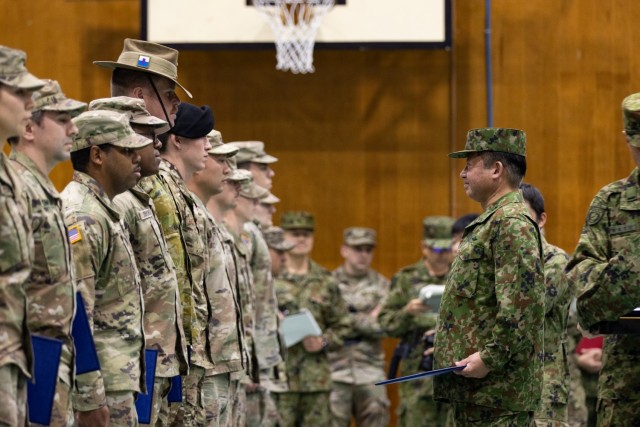 U.S. and Australian Army Soldiers are recognized by Japan Ground Self-Defense Force Lt. Gen. Ryoji Takemoto, the commanding general of the Ground Component Command, at the closing ceremony for Yama Sakura 85 in Camp Asaka, Japan, Dec. 12, 2023. As...