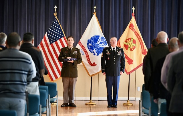 On the occasion of his retirement, CSM Traylor prepares to receive the American flag from Col. Kline, officially marking the end of his 31-year career as an active-duty soldier during a retirement ceremony at the Weckerling Center, Presidio of Monterey, Calif., Dec. 12.