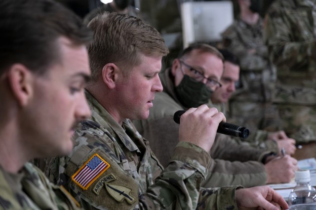 U.S Army Maj. Drew Deal, Psychological Operations Officer for the 11th Airborne Division, speaks during an information operations scenario brief during Yama Sakura 85 at Camp Higashi-Chitose, Japan, Dec. 7, 2023. The information operations working...