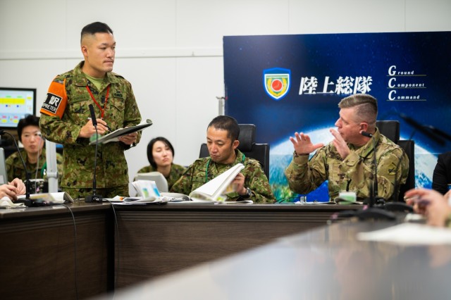 U.S Army Col. Jeffery Schwab, the deputy commander of 364th Civil Affairs Brigade, shares his thoughts while Sgt. Kei Fukuda, an interpreter with the Japan Ground Self-Defense Force, translates during a civil affairs working group in Camp Asaka,...