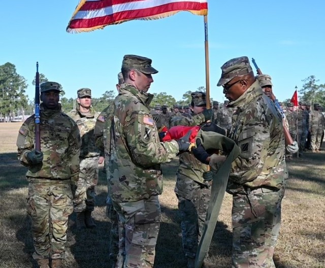 Georgia Army National Guard Soldiers from the 1st Battalion, 118th Field Artillery Regiment conduct a colors casing ceremony Dec. 12, 2023, in Fort Stewart, Ga., before deploying overseas.