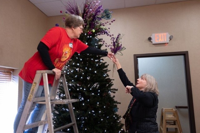 Katie Miceli, left, and Kate Moentmann decorate a tree at The Summit. 