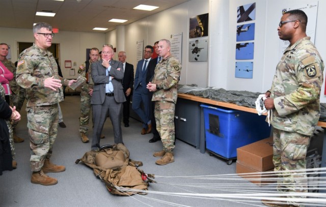 GEN James E. Rainey, commanding general of U.S. Army Futures Command (AFC), discusses personnel parachutes with Senior Airdrop Systems Technician Chief Warrant Officer 4 Terry Wright during a visit to DEVCOM Soldier Center in Natick, Massachusetts on Nov 7, 2023.