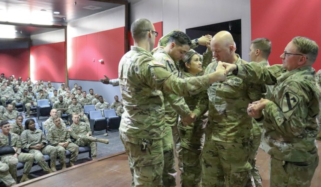 Soldiers participate in a group exercise during the performance of &#34;Second Chance&#34; play Dec. 6. The Soldiers were invited on stage from the audience, which is part of the hands-on approach the play takes to demonstrate the material. (U.S....
