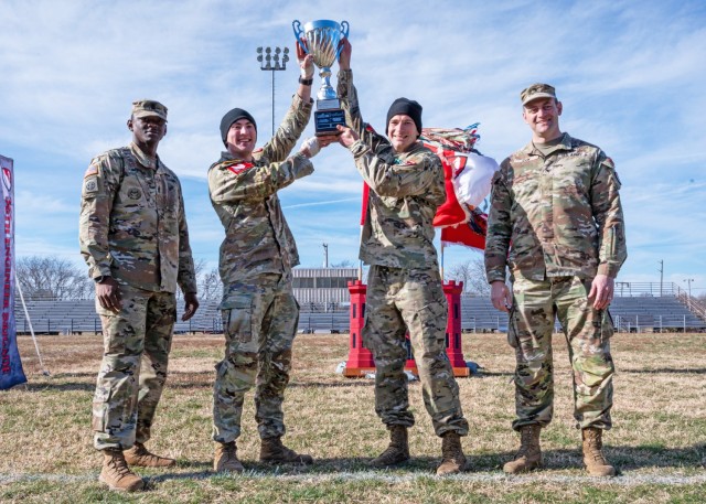 Capt. Robert Skinker (center, right) and 1st Lt. Luke Orsay, with the 5th Engineer Battalion, raise the Rugged Best Sapper Competition trophy, presented by Col. Aaron Cox, 36th Engineer Brigade commander (right), and 36th En. Bde. Command Sgt....