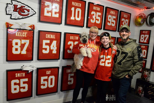 The Fuller family — Katrin Fuller, retired Command Sgt. Maj. Mike Fuller, 13-year-old Maddie Fuller (aka KC Chiefs Goggle Girl), and the family’s Maltese/Yorkshire terrier mix Tucker — in their Chiefs-themed “Fam Cave” Nov. 30 in...