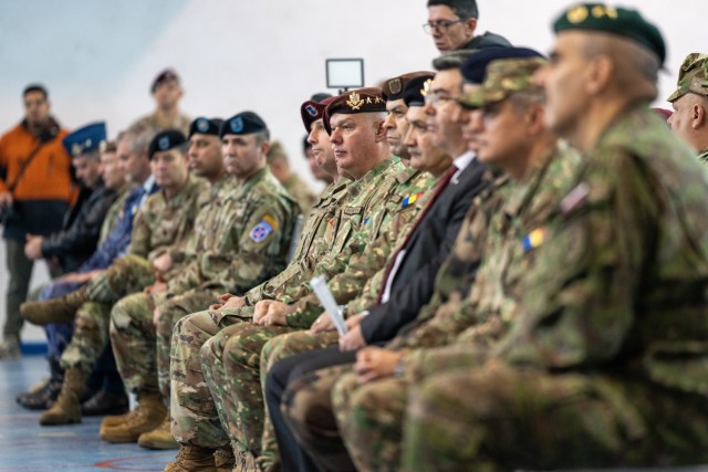 U.S. Army Paratroopers from the 82nd Airborne Division, "Taks Force 82", soldiers from the 10th Mountain Division, "Task Force Mountain", and Romanian military defense counterparts, watch the transfer of authority ceremony hosted by the U.S. Army’s V Corps, at Mihail Kogalniceanu Air Base, Romania, Dec. 15. The soldiers and paratroopers assigned to TF 82 support the U.S. Army V Corps’ mission to reinforce NATO’s eastern flank, assure European allies and partners, and deter aggression. (U.S. Army Photo by Sgt. 1st Class Jonathan Hornby)