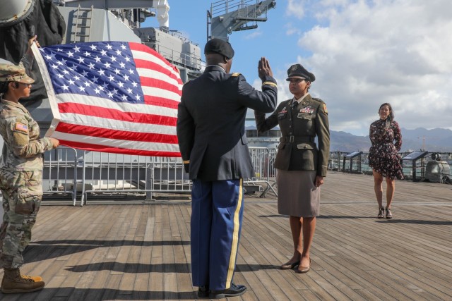 8th Military Police Brigade’s Accountable Property Officer, Chief Warrant Officer 2 Johannis Parris repeats the Oath of Office given by 8th Theater Sustainment Command’s Senior Property Accountability Technician, Chief Warrant Officer 4 Meeklin Jeanbaptiste officially promoting her to the rank of Chief Warrant Officer 3 on the USS Missouri, Ford Island, Hawaii, Nov. 17, 2023. During the ceremony Parris was pinned by the 8th Military Police Brigades Logistics Officer, Maj. Jesse Holodak, and best friend from Puerto Rico Leslie Morales.