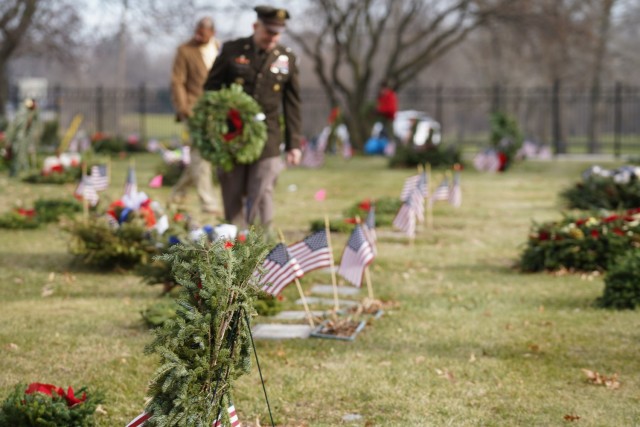 Lalor walks by a row of Veteran graves.