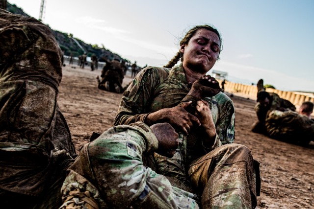 U.S. Army Sgt. Liliana Munday, a Soldier with 218th Maneuver Enhancement Brigade, South Carolina National Guard, Combined Joint Task Force - Horn of Africa, practices grappling techniques with another Soldier as a part of combative training during...