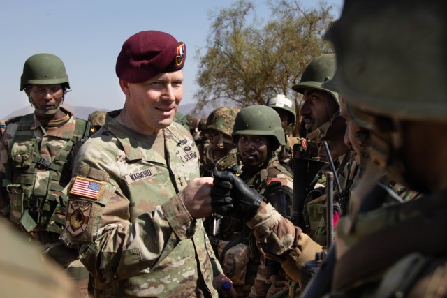 U.S. Army Maj. Gen. Todd Wasmund, commanding general of U.S. Army Southern European Task Force, Africa (SETAF-AF), gives a fist bump at the completion of a field training exercise during Justified Accord 2023 (JA23) in Isiolo, Kenya, Feb. 23, 2023. JA23 is U.S. Africa Command's largest exercise in East Africa. Led by SETAF-AF, this multinational exercise brings together more than 20 countries from four continents to increase partner readiness for peacekeeping missions, crisis response and humanitarian assistance. (U.S. Army Photo by Capt. Joe Legros)